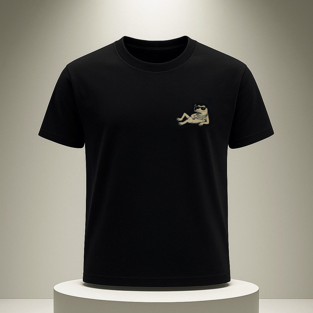 Black t-shirt with a small logo on a white pedestal against a gray background