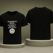 Black t-shirt with white text and smiley face on a gray background
